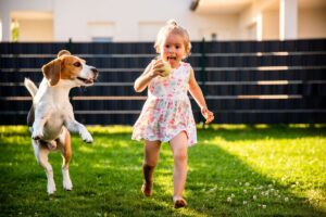 Menina correndo com cachorro.